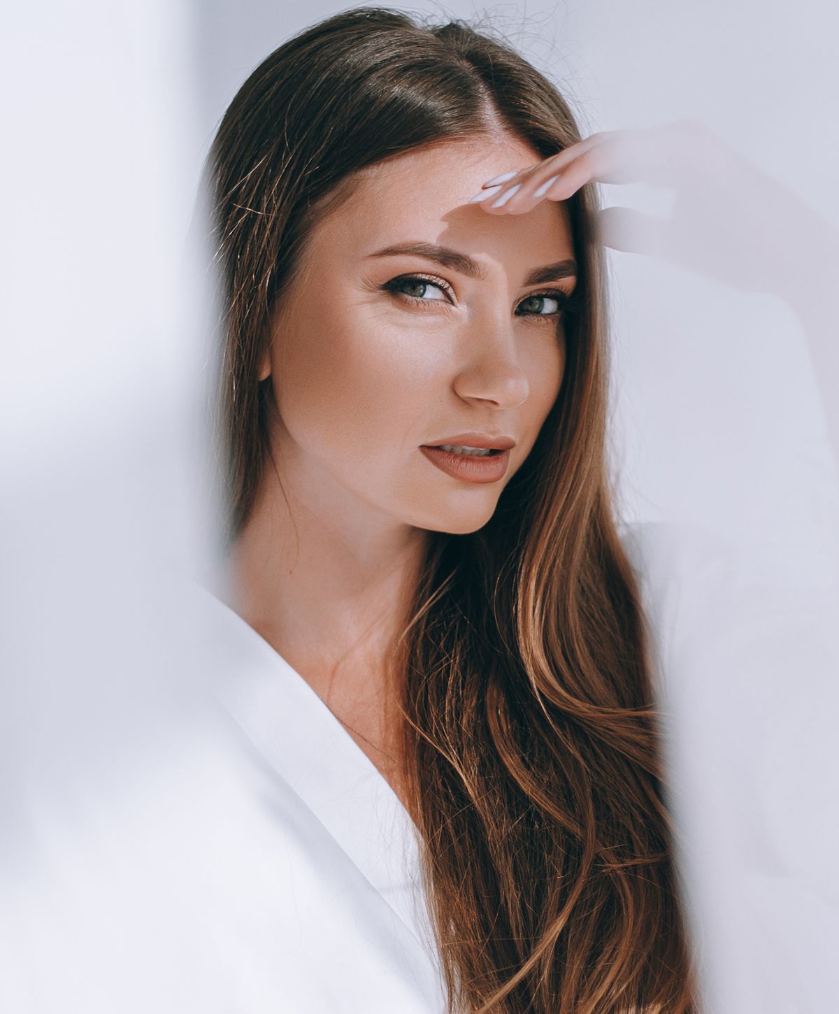 Woman with long hair in soft lighting.