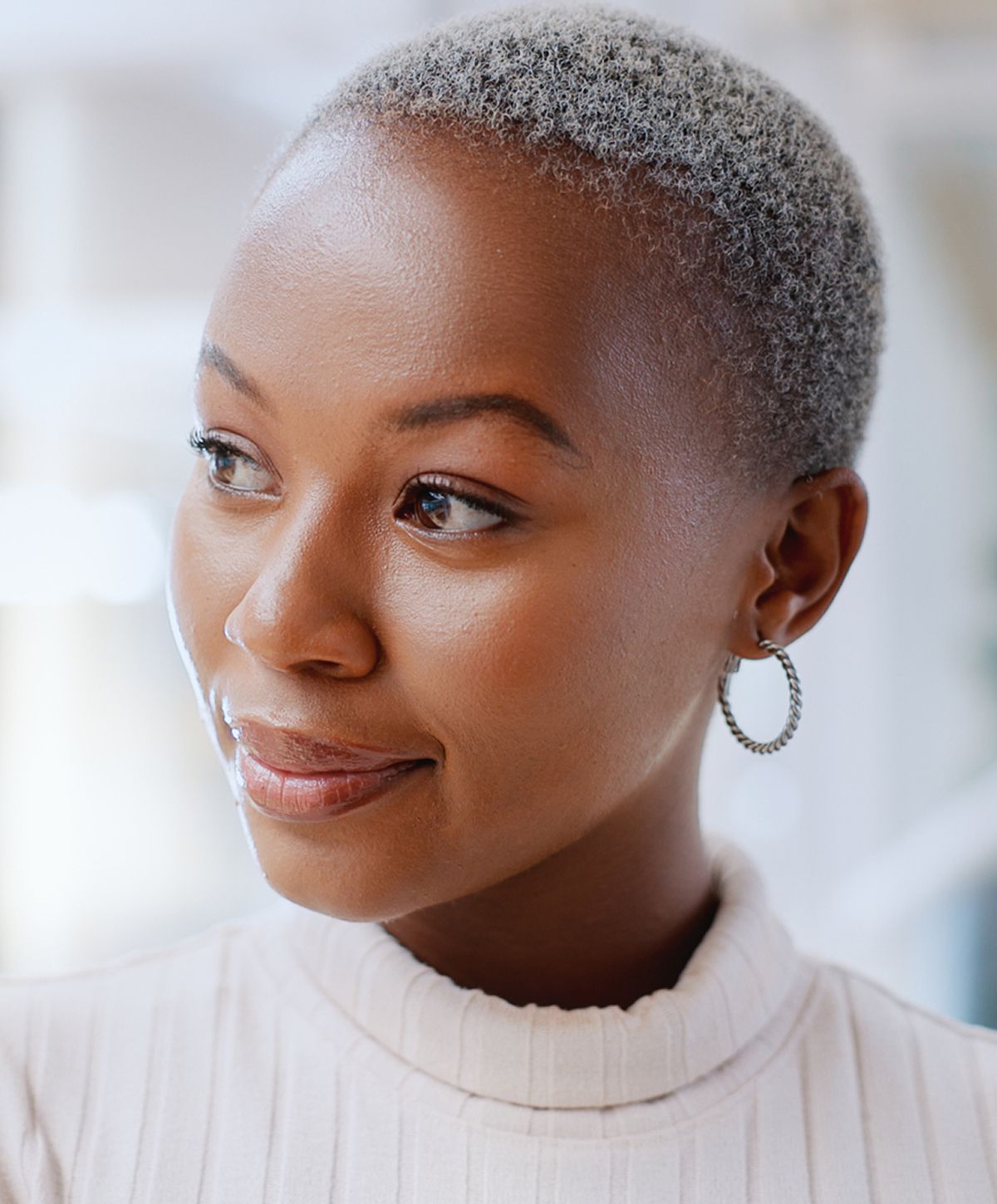Woman with short hair and hoop earrings.