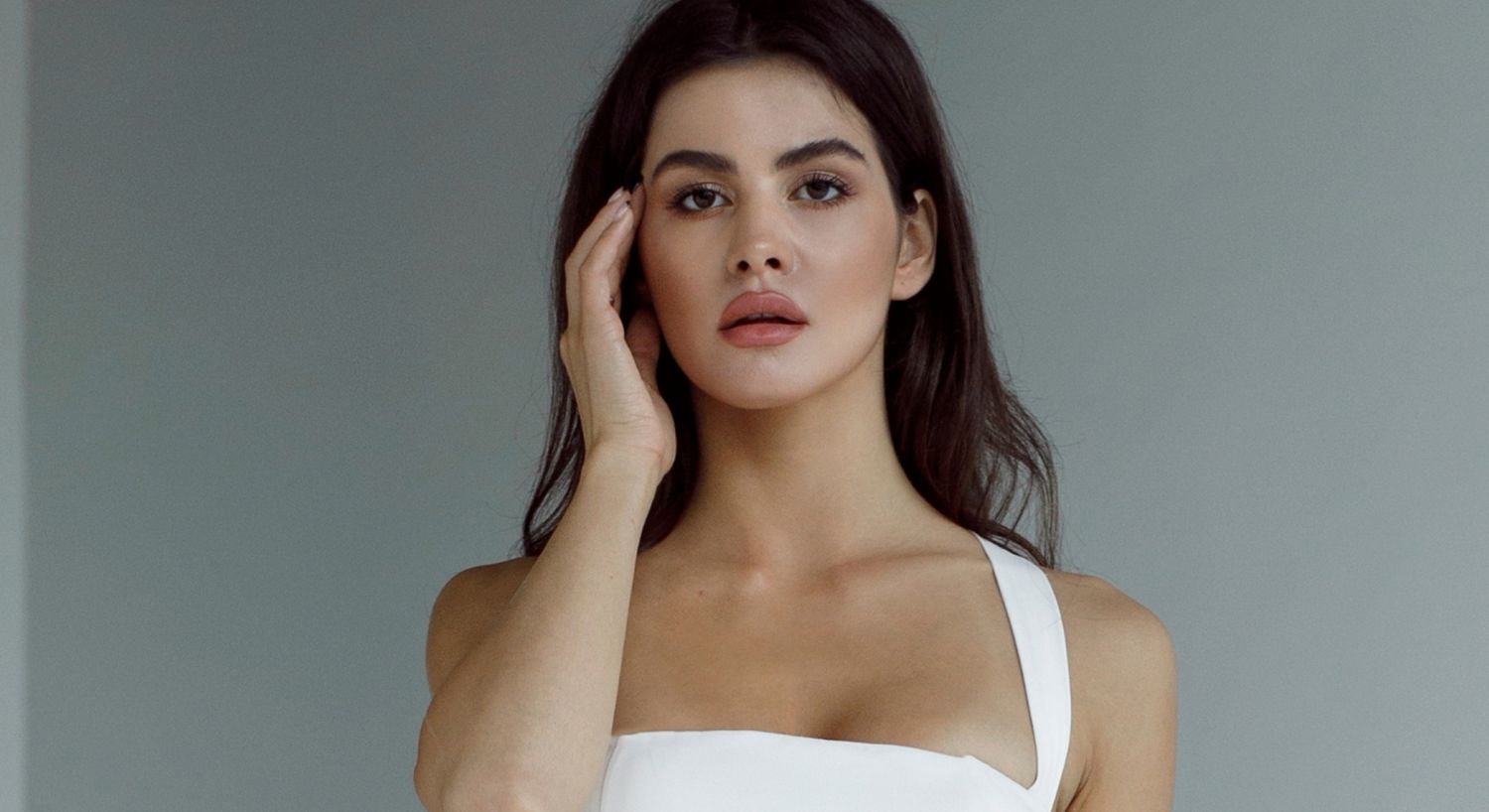 Woman with long hair in white dress.